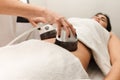 The procedure for vacuum anti-cellulite massage of the abdomen in a cosmetology clinic Royalty Free Stock Photo