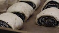 Proceeds for buns with poppy seeds. Lying on a baking sheet. Close-up