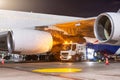 Process of aircraft jet airplane refueling by high pressure fuel supply truck at night Royalty Free Stock Photo