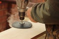 Process with angle grinder. Grinding of a wooden board 20 mm for the manufacture of furniture and shelves. An old man is working i