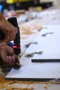 Process of apartment renovation. drilling holes in furniture by fettler. sawdust scatter. unrecognizable men. remodeling, doing