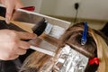 Process of applying bleaching powder on clients hair and wrapping into the foil.