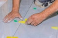 Working with a tile leveling system that uses plastic clips and wedges in bathroom construction