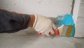 A worker is applying waterproofing paint to the floor in the bathroom. The process of applying waterproofing in the Royalty Free Stock Photo