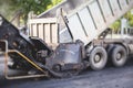 Process of asphalting, blacktopping and paving, asphalt paver machine and steam roller compactor during construction and repairing