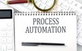 PROCESS AUTOMATION . Text on notepad with calculator and keyboard,business concept