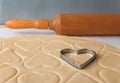 The process of baking cookies at home.Heart shaped cookie cutters cutting out holiday sugar cookies. St. Valentines Day. Side view Royalty Free Stock Photo