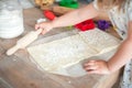 The process of baking from dough. hands roll out the dough and make cookies in the form of asterisks on the dough Royalty Free Stock Photo