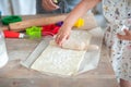 The process of baking from dough. hands roll out the dough and make cookies in the form of asterisks on the dough