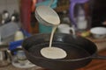 Process of baking of pancake on a pig-iron frying pan close up Royalty Free Stock Photo