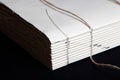The process of book binding; close up of a raw book after sewing on cords. Royalty Free Stock Photo