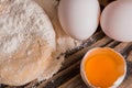 Process of Bread cooking. Preparation of dough for baking pies, bread, rolls and biscuits. Flour with eggs on a wooden dark backgr Royalty Free Stock Photo