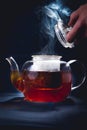 Process brewing tea,tea ceremony,Cup of freshly brewed black tea,warm soft light, darker background