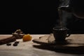Process brewing tea, dark mood. The steam from hot tea is poured from the kettle. Royalty Free Stock Photo
