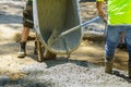 Process while building new pavement, wheelbarrow of mortar for pouring the foundation Royalty Free Stock Photo