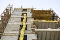 The process of building a residential building. Scaffolding, yellow chute, safe waste disposal. Open facade. View from below.