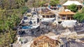 The process of building wooden villas on the tropical island of Bali. Drone view of a wooden cottage. House with a Royalty Free Stock Photo