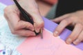 Process of calligraphy handwriting with an ink fountain pen feather, calligrapher practicing writing on a postcard paper using pen