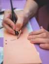 Process of calligraphy handwriting with an ink fountain pen feather, calligrapher practicing writing on a postcard paper using pen