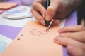 Process of calligraphy handwriting with an ink fountain pen feather, calligrapher practicing writing on a postcard paper using pen