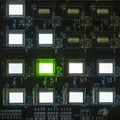 The process of checking several oled displays on the test station. Displays glow brightly of green and white color close up