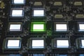 The process of checking several oled displays on the test station. Displays glow brightly of green and white color close up