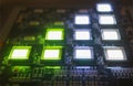 The process of checking several oled displays on the test station. Displays glow brightly of green and white color close up