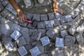 The process of circular laying of granite paving stones, top view. A man lays cobblestones made of natural stone in a circle and Royalty Free Stock Photo
