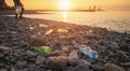 Process of cleaning stone beach from plastic waste. Man picks up plastic bottles in trash bag. Environmental pollution Royalty Free Stock Photo