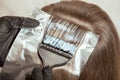 The process of coloring a lock of hair close-up Royalty Free Stock Photo