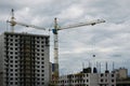 The process of construction. Building materials are delivered to a multi-storey building under construction using a lifting cran