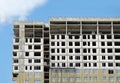 Process of construction high-rise modern apartment building with penthouse over blue sky in sunny day Royalty Free Stock Photo