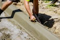 The process of construction of the sidewalk, the installation of a curb Royalty Free Stock Photo