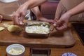 Process of cooking baked gratin potatoes hands rustic decor