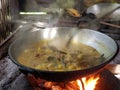 the process of cooking rendang or beef and chicken curry using the traditional method, cooking using firewood