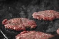Process of cooking cheeseburgers on the grill. Close up beef meat burgers for hamburger. Royalty Free Stock Photo