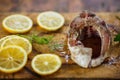 The process of cooking fish, one fresh raw tasty piece of fish with lemon slices and parsley on wooden Board Royalty Free Stock Photo