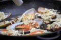 The process of cooking fried mussels with cheese in a frying pan Royalty Free Stock Photo