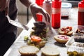 Process of cooking hamburger. chef on the kitchen table making out the ingredients of the Burger. Beef Patty cooked on Royalty Free Stock Photo