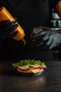Process of cooking hamburger. chef on the kitchen table making out the ingredients of the Burger. Beef Patty cooked on Royalty Free Stock Photo