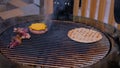 Process of cooking pieces of meat, burgers bums, cutlet and pita on grill Royalty Free Stock Photo