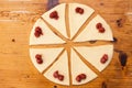 Process of cooking small croissants with cherry for breakfast. Pieces of dough with cherry filling.