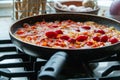 Process of cooking tomato sauce for pasta in a by the ingredients: onion, greens, radish, tomato, paprika and red pepper Royalty Free Stock Photo