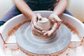 Process of creating and formation a white clay ceramic plate. Professional potter is engaged in modeling clay plates. Potter works Royalty Free Stock Photo