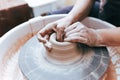 Process of creating and formation a white clay ceramic plate. Professional potter is engaged in modeling clay plates. Potter works Royalty Free Stock Photo