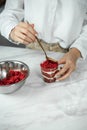Process of creating red velvet trifle. Confectioner at work
