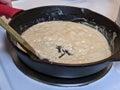 Process of creating a roux out of flour and butter in a cast iron skillet Royalty Free Stock Photo