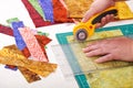 Process cutting fabric pieces by rotary cutter on mat using ruler