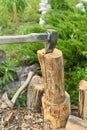 The process of cutting wood with a cleaver. Axe in the log