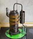 The process of distilling wine at a mini distillery using wood. Volume 400 ml. Royalty Free Stock Photo